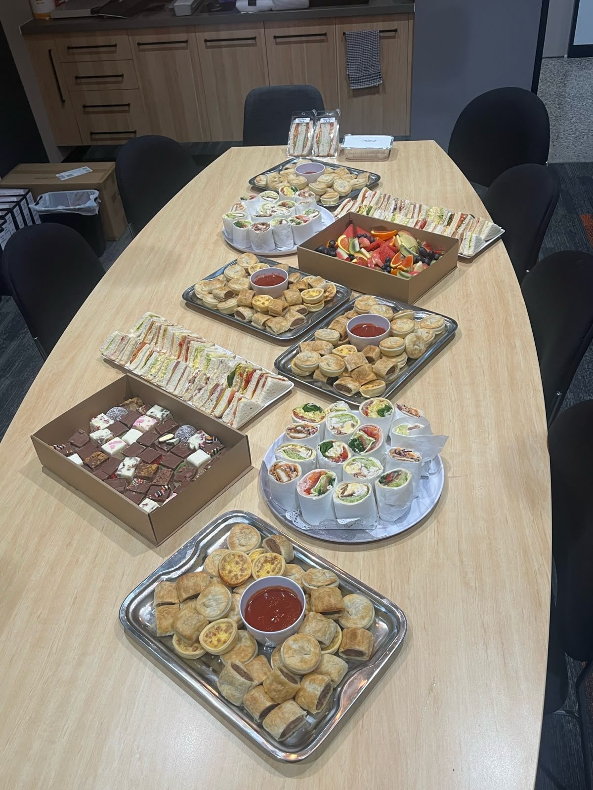 Ballarat Catering Company catering spread with sandwich points, gourmet wraps, party pies, sausage rolls, mini quiches, fresh fruit and dessert slices